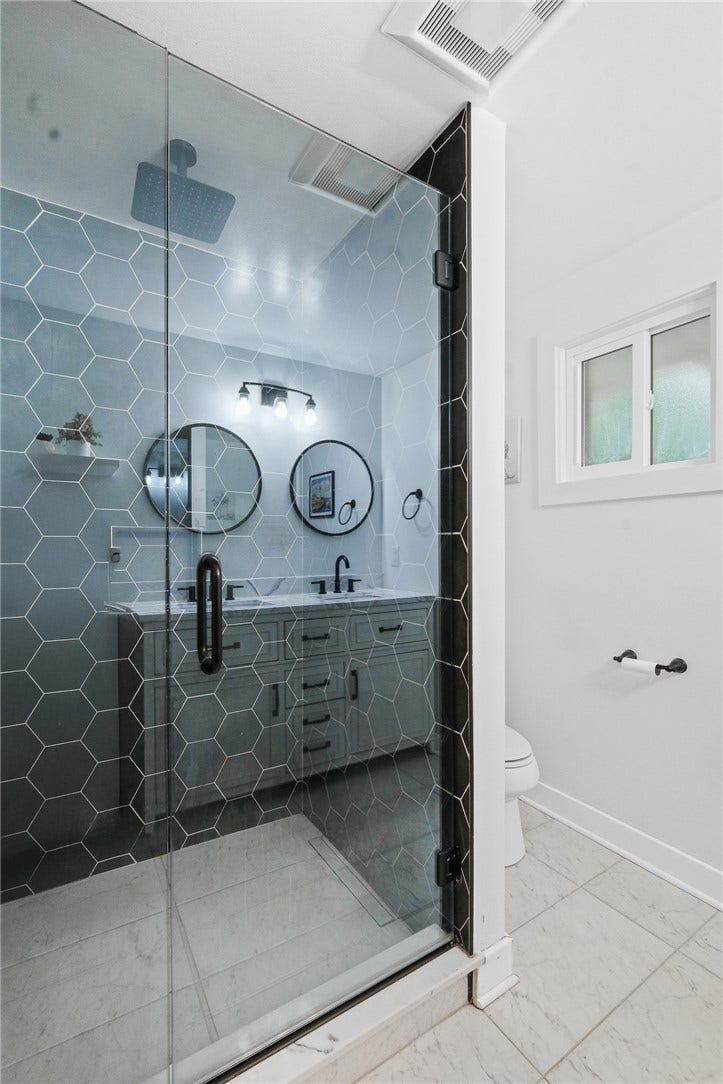 Check out this gorgeous ceramic tile shower w/glass doors!