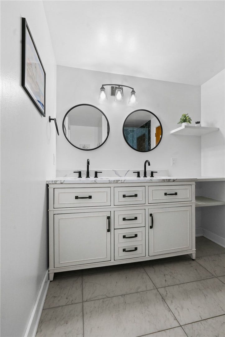 Gorgeous double bowl vanity with mirror, lighting, & shelving! All new!