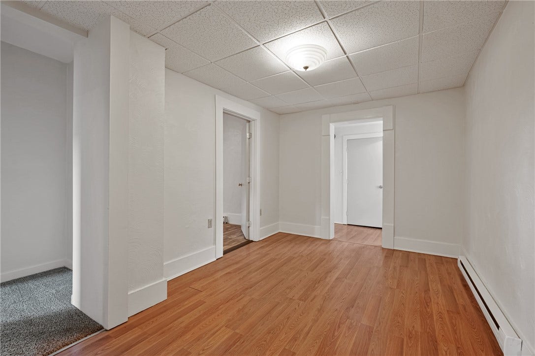 Common area. Connects kitchen, bathroom, 2 beds, and mud room