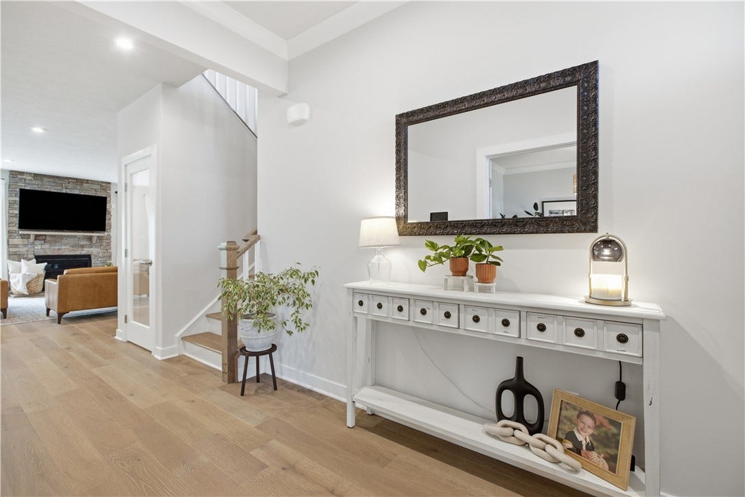 Welcoming foyer with engineered hardwood throughout, soaring ceilings, and an open, inviting floor plan.