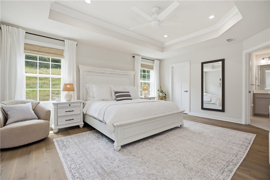 Featuring a walk-in closet with custom organization, double hanging space, shelving, and generous storage capacity.