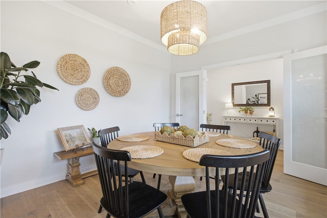 Spacious dining room with elegant trim, contemporary lighting, and convenient access to the main living areas.