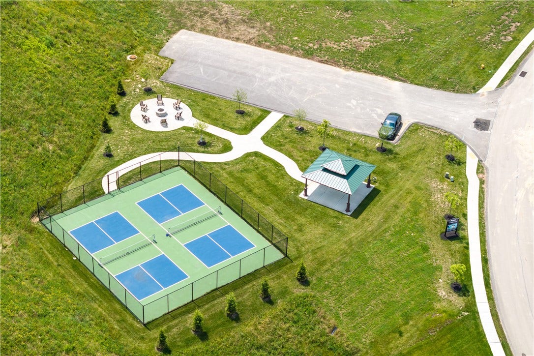 Community fire pit area and pickleball courts.