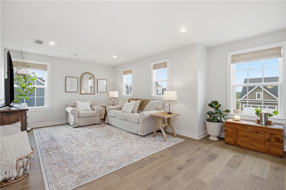 Sun-filled upper-level family room provides the perfect secondary gathering space for movies, games, or quiet relaxation.
