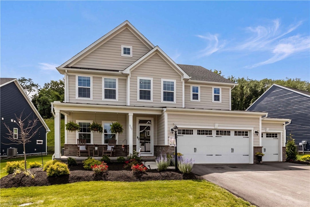 Charming covered front porch, attractive landscaping, and oversized three-car garage create exceptional curb appeal.