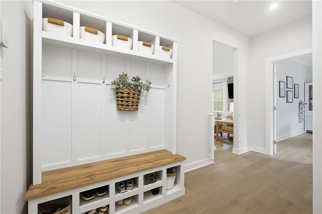 Functional mudroom area off the garage with built-in bench, cubbies, hooks, and storage to keep everyday life organized.