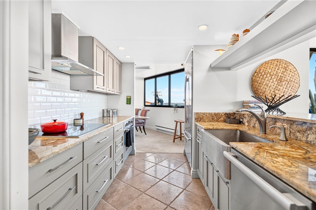 1 Trimont Ln, #490E, Pittsburgh, PA 15211 Kitchen looking toward the city:
Redesigned Kitchen with sleek cabinetry, granite counters, stainless appliances, farmhouse sink & cooktopplus a city view beyond.