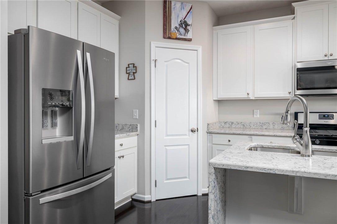 Kitchen island with seating - pristine hardwood floors that flow beautifully to the kitchen area.