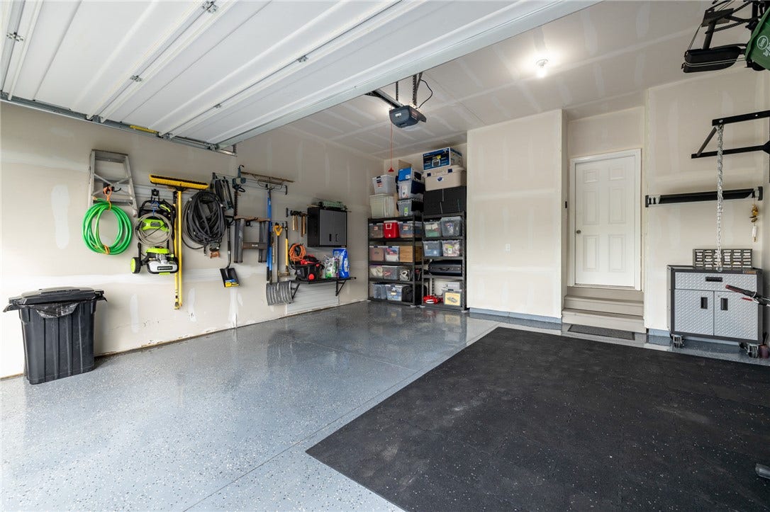 Sealed garage floor with lots of shelving.