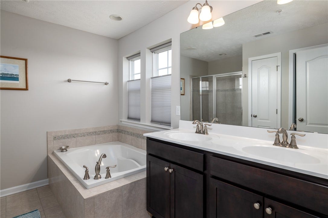Double vanities, soaking tub and separate shower...ceramic tile. The perfect escape right at home!