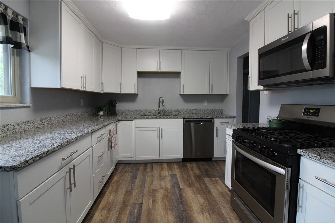 An abundance of cabinet space and beautiful flooring.