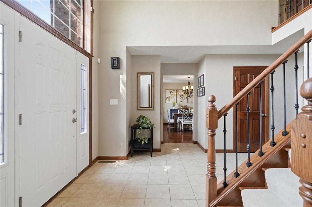 Front Door with Side Lights to Entry - Open to Dining/Living Rooms, with Coat Closet and Guest 1/2 Bath.