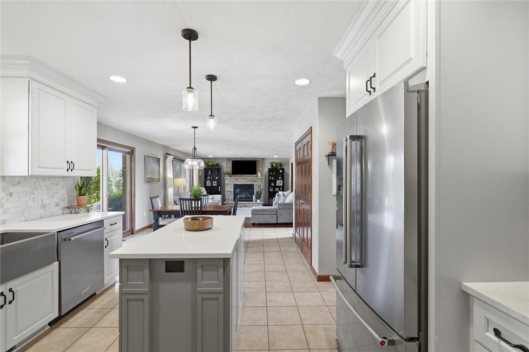 KitchenAid Stainless Steel Appliance Suite Including Dutch Door Refrigerator with Ice, Water, and Bottom Freezer.