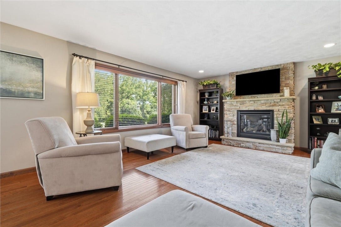 19x15 Family Room with Beautiful Hardwood Floors and Wall of Windows with Fixed Picture Window at Center.