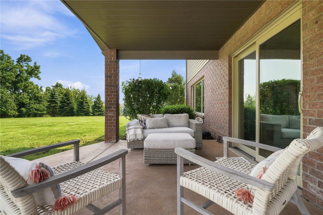 Relaxing Covered Patio off the Kitchen and Open to the Yard and Pool Area.