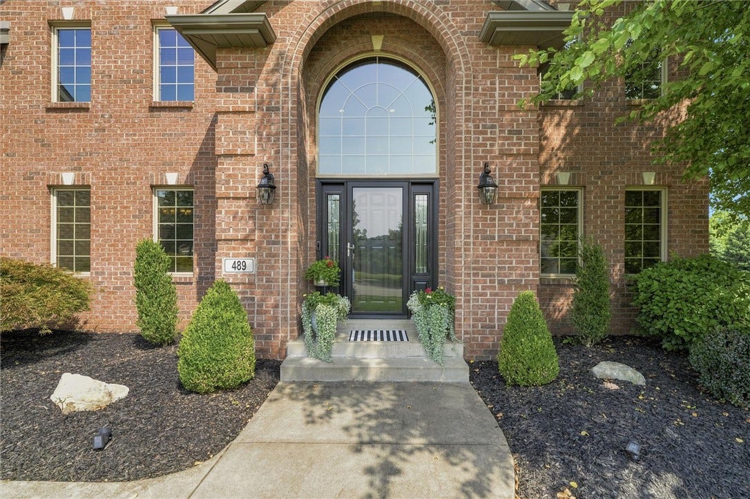 Impressive, Arched Brick, Covered Entry with Coined Brick and Lovely Keystone Details.