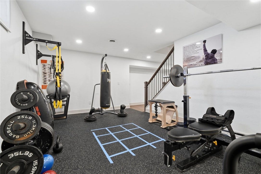 Another View of the Gym - Wall Mounted Pull Up Bar and Rubber Gym Floor Stay with the Home.