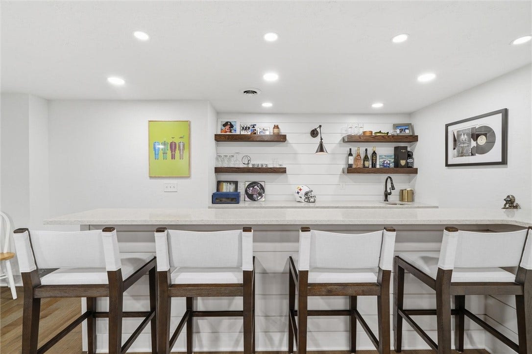 Gorgeous 12 Ft, Quartz Topped Bar in Gameroom with Wine Chiller, Floating Shelves, Shiplap Wall, and Wet Sink.