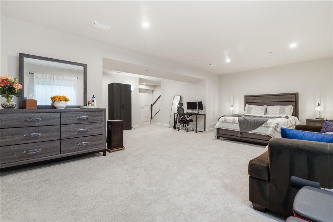 View from corner of room towards staircase and walk-in closet door.