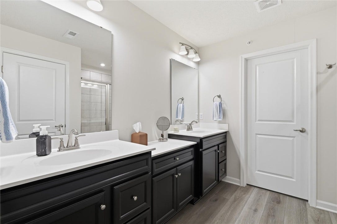 Primary bath features a double vanity with a dedicated make-up area.