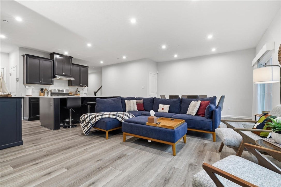 Recessed lighting and Wood look Luxury Vinyl Flooring throughout main living area.