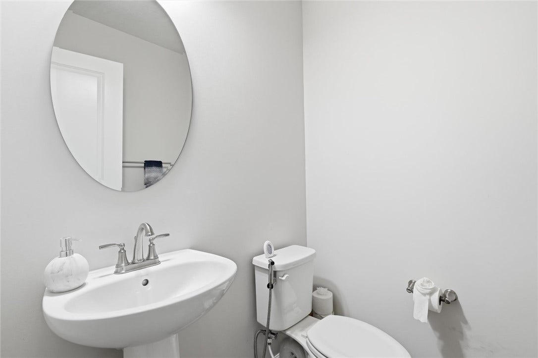 Main Floor guest bathroom with pedestal sink.