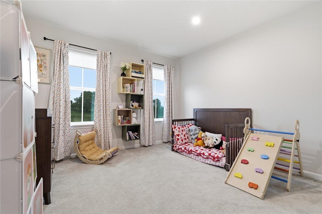 Bedroom #2-13x11-Shelving on wall can stay.  Custom blinds included.  All curtains are excluded.