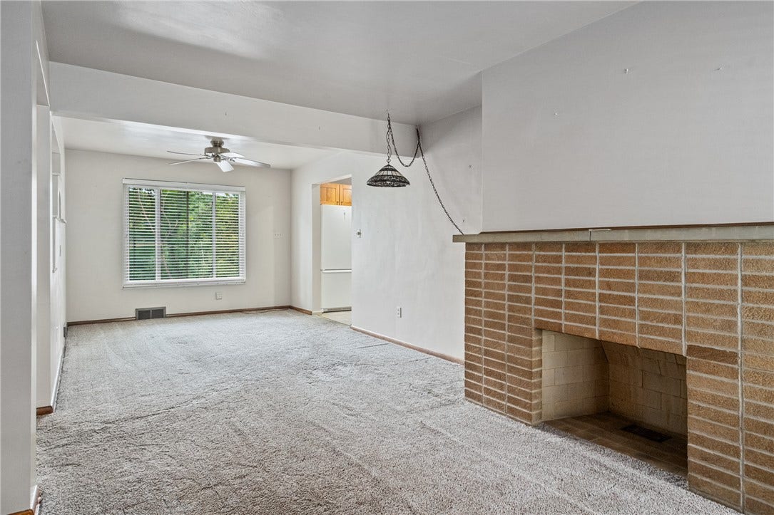 Step inside to the living area with decorative fireplace