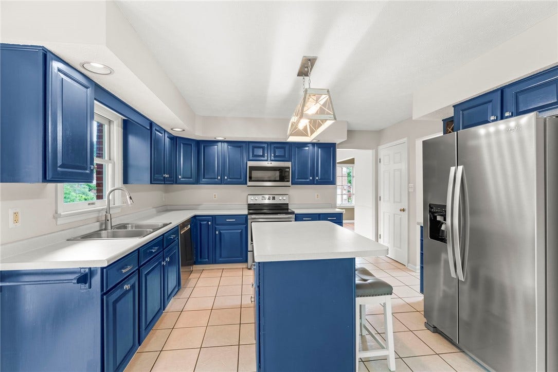 The spacious eat-in kitchen is truly the heart of the home, offering stainless steel appliances, abundant counter space, a large center island perfect for meal preparation, casual dining, or homework time, and plenty of room for gathering with family and friends.