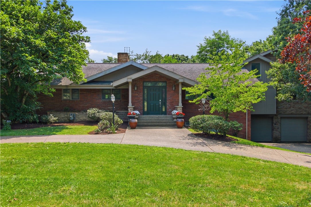 2072 Outlook Drive, Pittsburgh, PA 15241 A timeless brick estate set on 1.67 private acres, offering exceptional curb appeal and a peaceful Upper St. Clair setting.