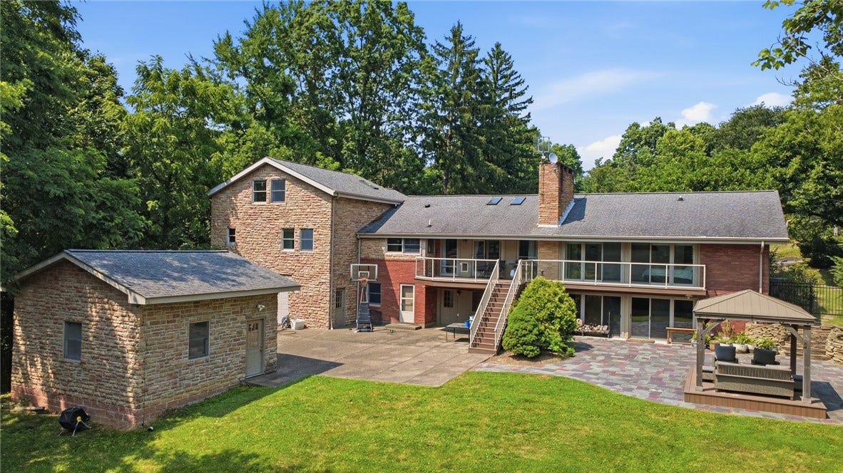 2072 Outlook Drive, Pittsburgh, PA 15241 The expansive rear elevation showcases multiple outdoor living spaces designed for entertaining and relaxation.
