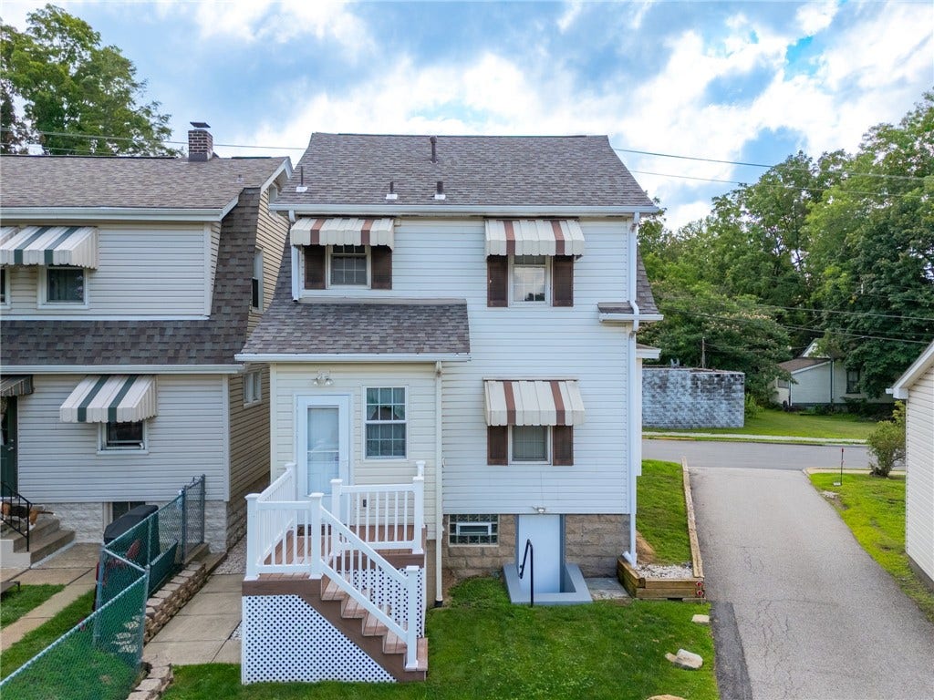 169 Allegheny Ave, Pittsburgh, PA 15202 Rear of home with back door from Kitchen to low maintenance deck and steps. Walkout basement door is an added bonus!