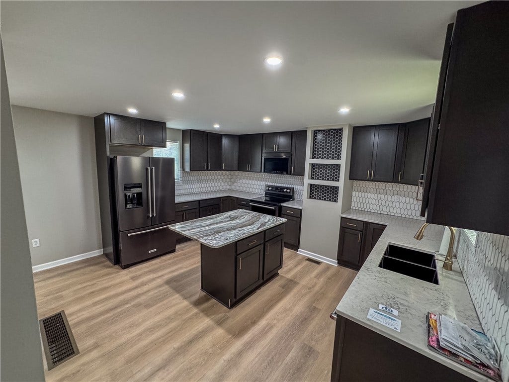 Home includes all new black stainless appliances