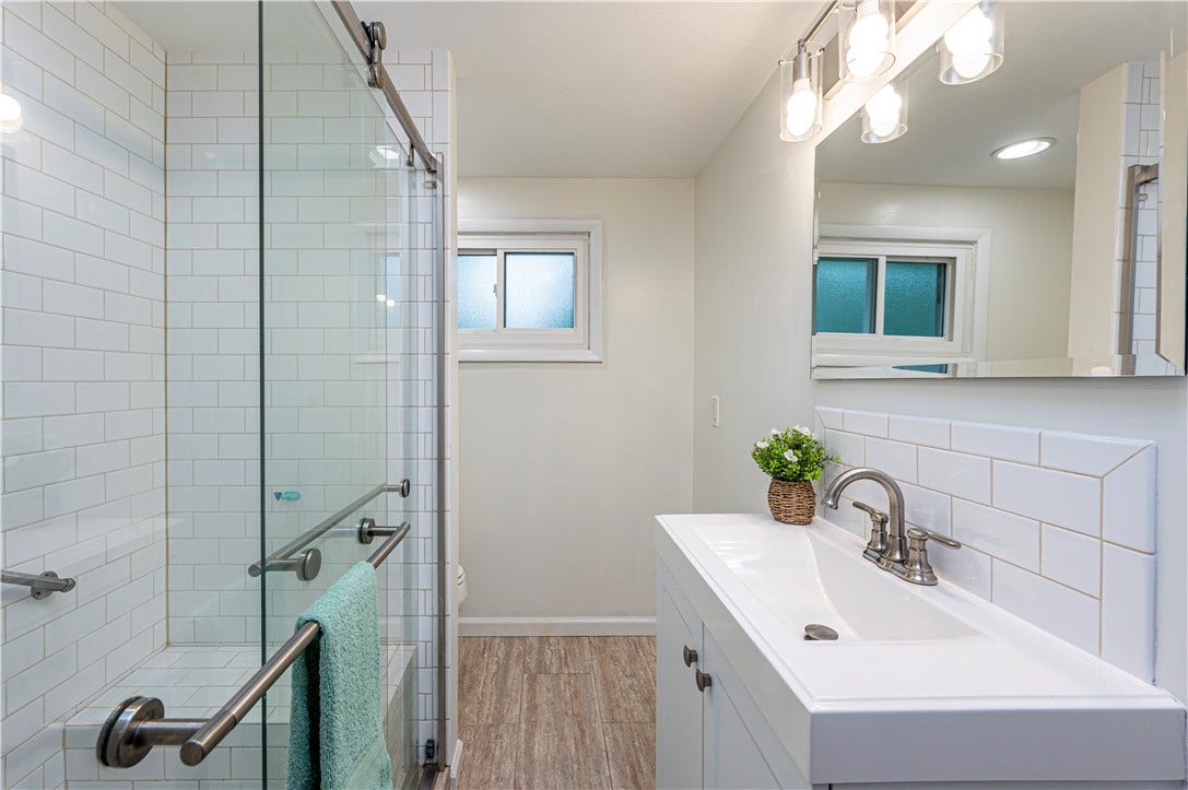 Love this updated main bath with a walk in closet with glass doors.