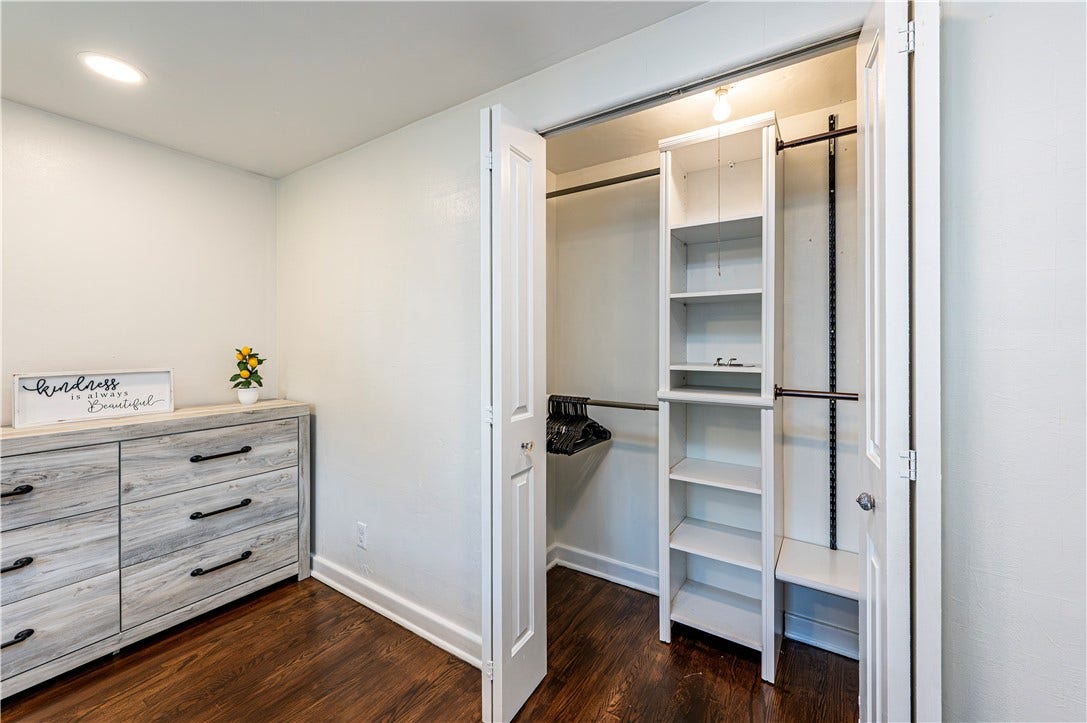 The primary bedroom features organizers in the closet area.