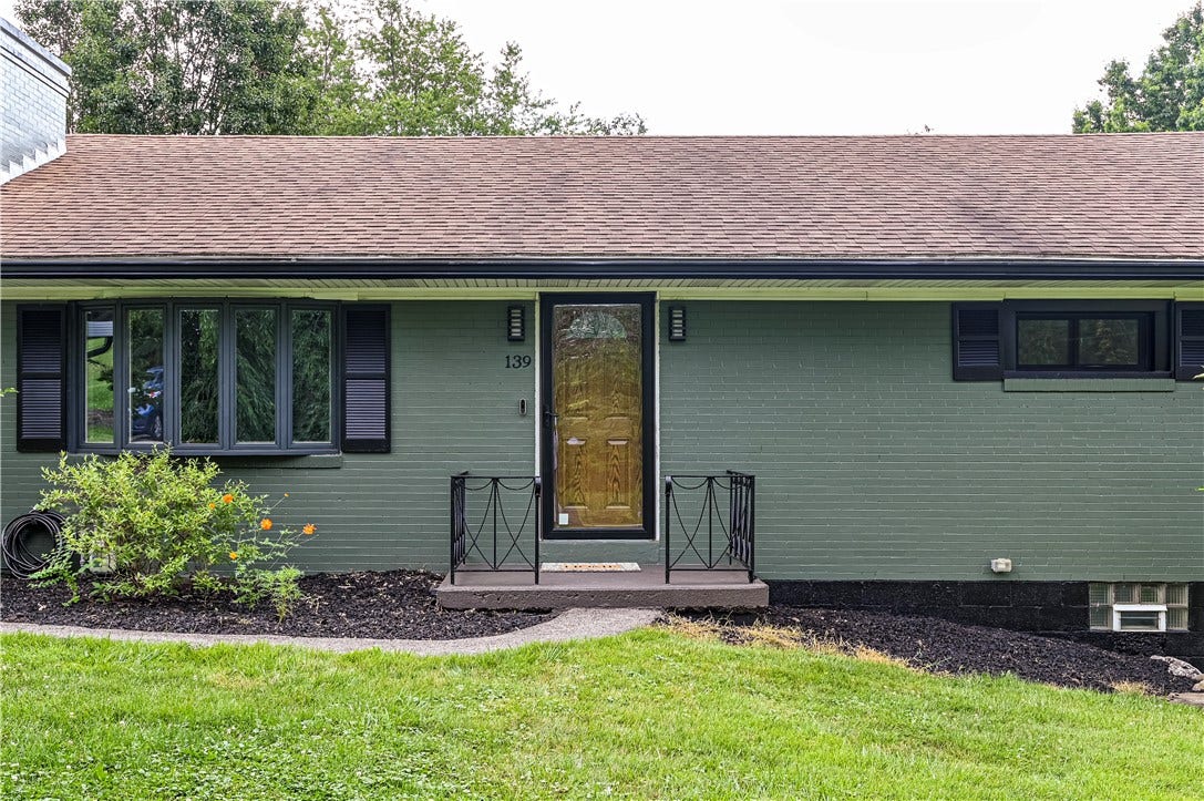 Love the new grey/green tone pained brick with all of the black accents.