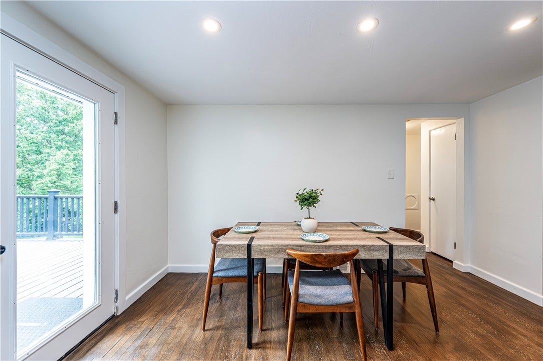 The dining area has a great view of the outside deck and tranquil backyard.