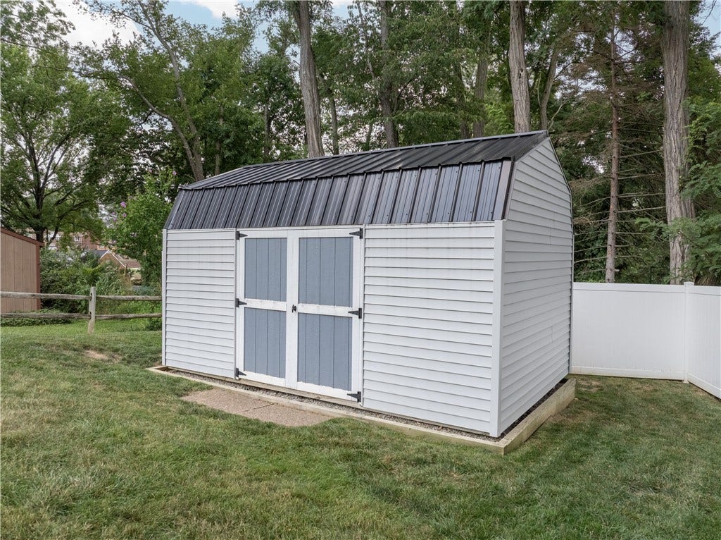 This storage shed provides an ideal space for organizing lawn maintenance equipment.