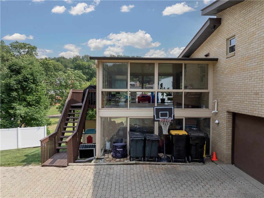 Side of Structure - Includes stacked sun rooms and stairs leading to the deck.