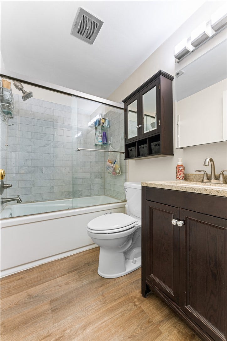 Full bathroom remodeled six years ago with luxury vinyl flooring, new vanity, updated toilet, and glass shower enclosure.