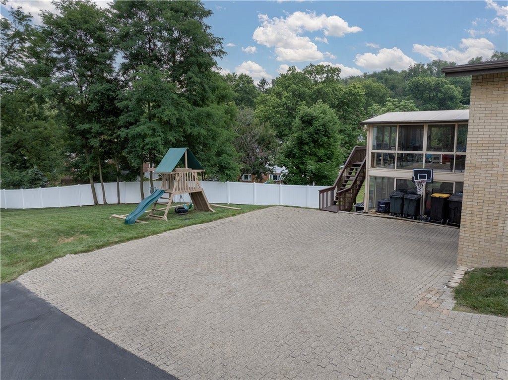 Back yard features a white 6ft vinyl privacy fence along the rear and side perimeter.