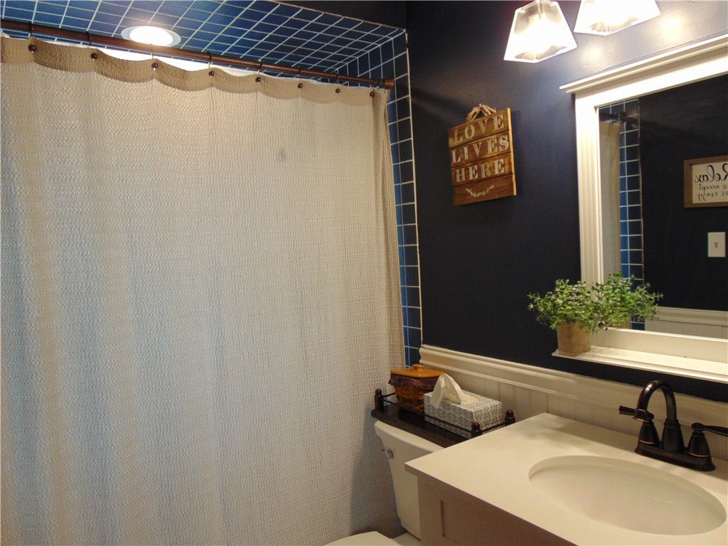 First floor bathroom with ceramic tub/shower combination