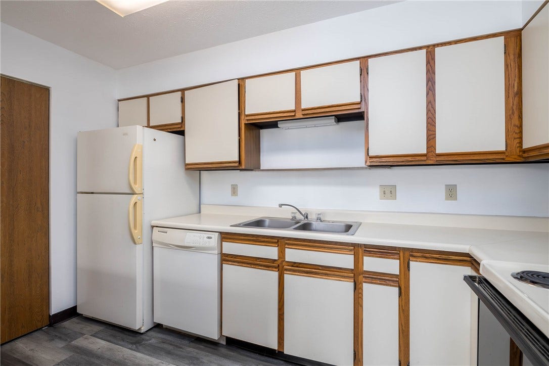 Kitchen with view to pantry and new flooring.