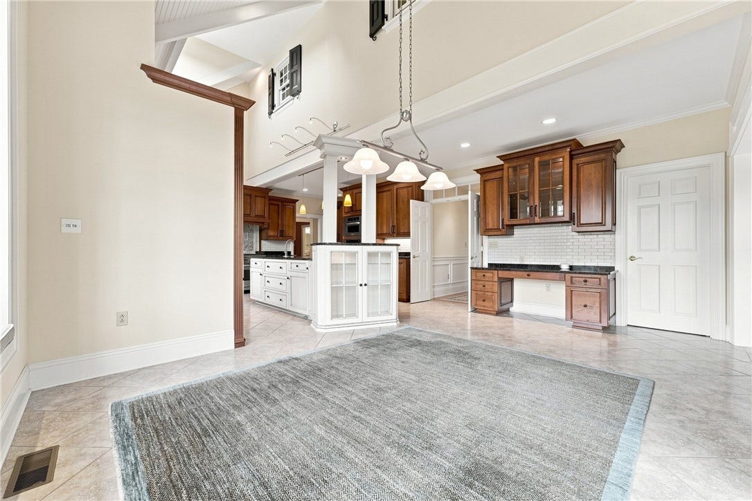 Ample custom cabinetry throughout, along with a walk-in pantry, provide storage for all your meal prep and serving tools