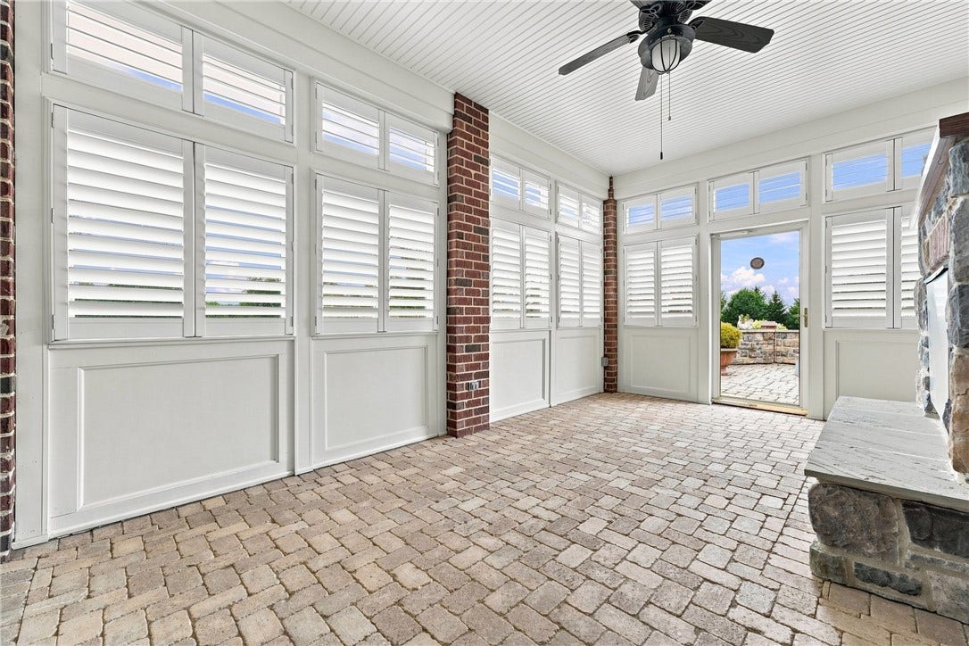 Located just off of the family room, you'll find this wonderful three season (four seasons if you use the fireplace!) where you can open the blinds and enjoy every day of sun we have.