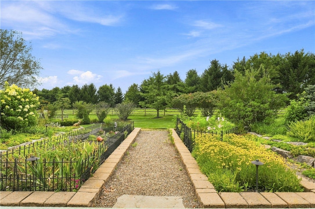 Strolling through the gravel paths among the beautiful gardens of the backyard.