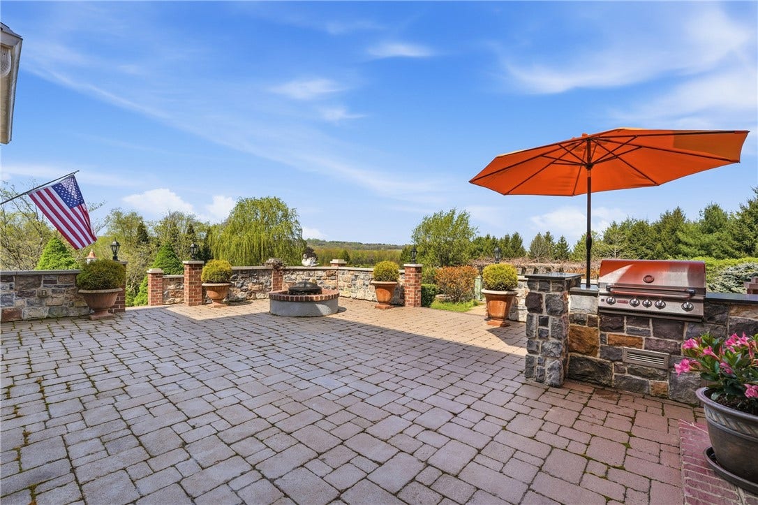 The grand flagstone patio creates a beautiful space for entertaining and relaxing as you look out over the stunning beauty of the surrounding grounds.