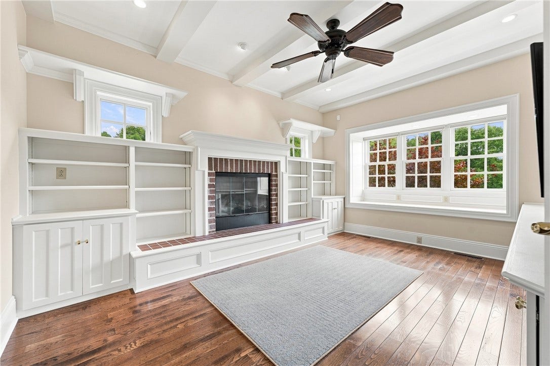 The details of the built ins, the ample light, the cozy fireplace...all this will make this office your perfect hideaway.