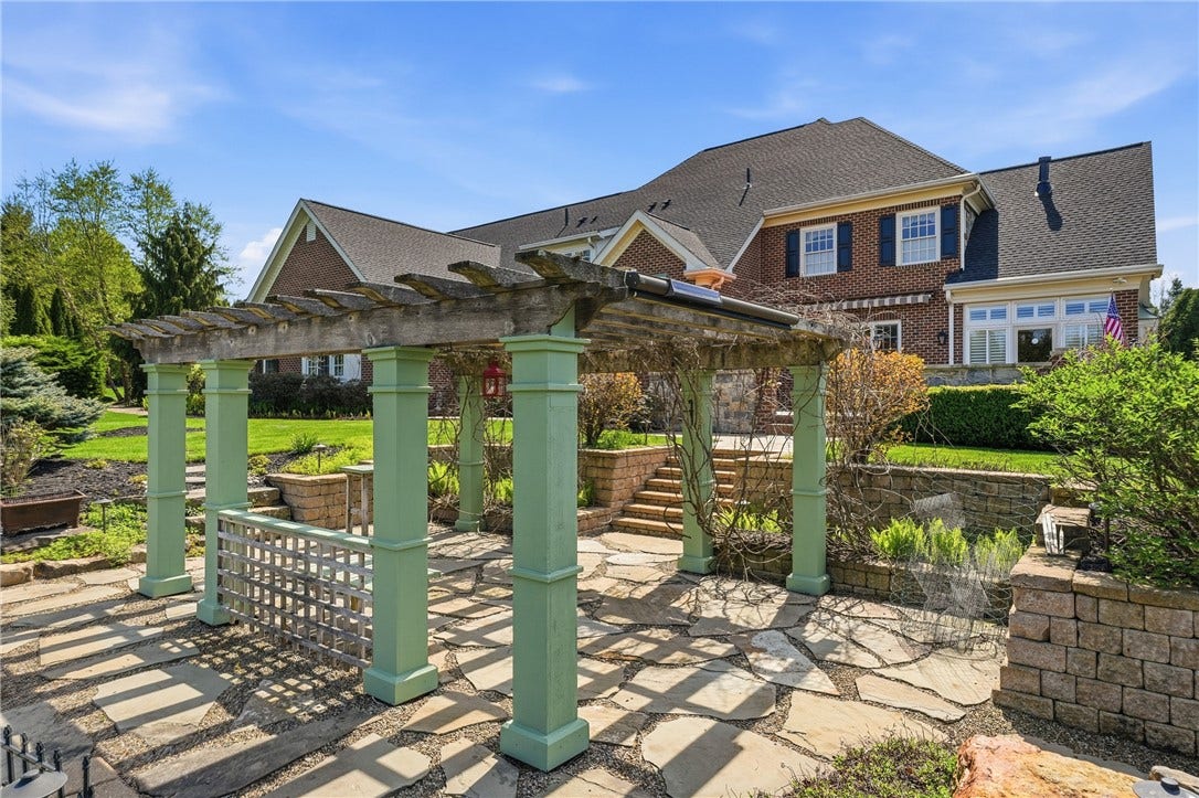 The fabulous pergola is covered in gorgeous blooming wisteria in the spring and summer months