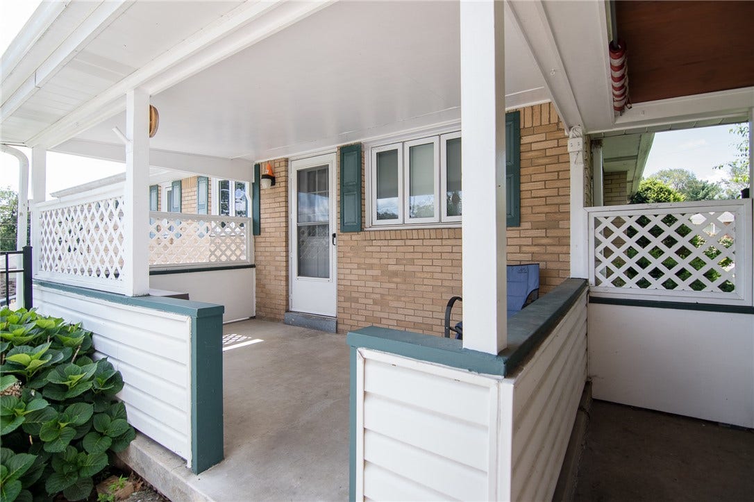 Covered back porch gives additional space to the covered patio that sits next to it.